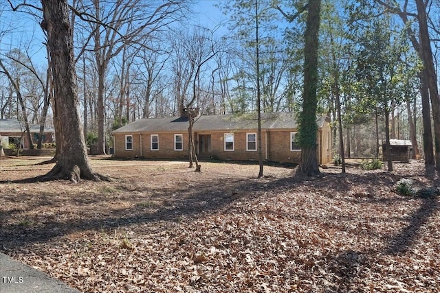 ranch-style house featuring brick siding