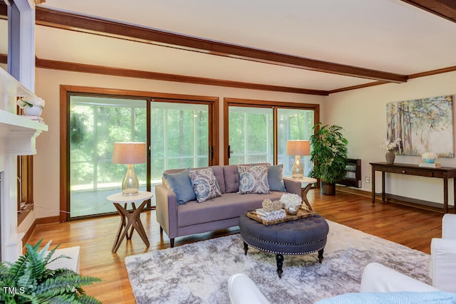 living room featuring beamed ceiling, light wood-style floors, and baseboards