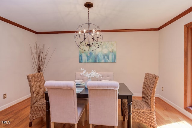 dining room with baseboards, light wood-style floors, and crown molding