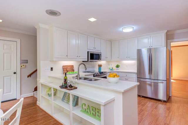 kitchen featuring stainless steel appliances, light wood-style floors, white cabinets, and light countertops