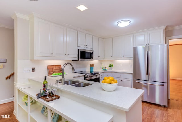 kitchen featuring white cabinets, appliances with stainless steel finishes, and a sink