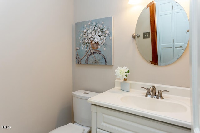 half bath featuring toilet and vanity