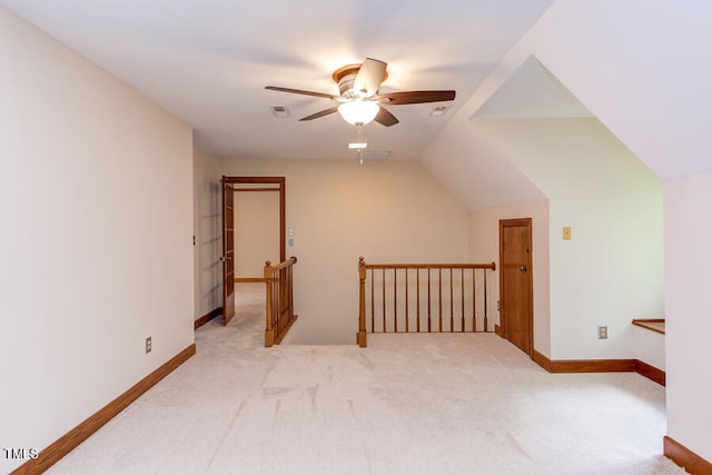 bonus room featuring baseboards, light colored carpet, ceiling fan, and vaulted ceiling