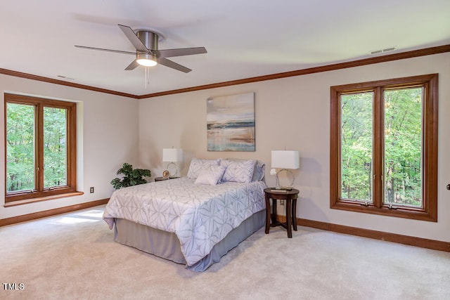 bedroom featuring multiple windows, ornamental molding, visible vents, and light carpet