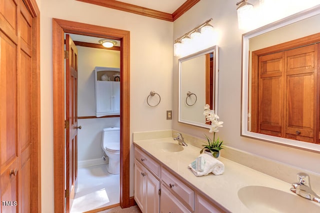 bathroom with a sink, toilet, ornamental molding, and double vanity