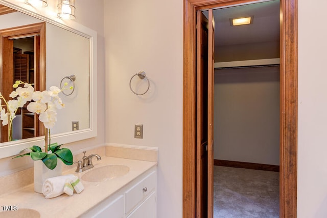 bathroom with vanity and baseboards