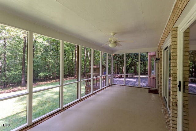 unfurnished sunroom with a ceiling fan