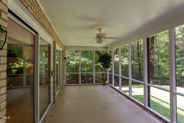 unfurnished sunroom with a ceiling fan