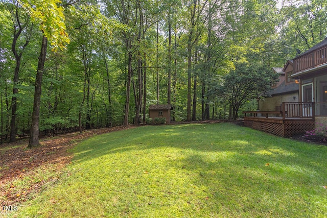 view of yard featuring an outdoor structure and a deck