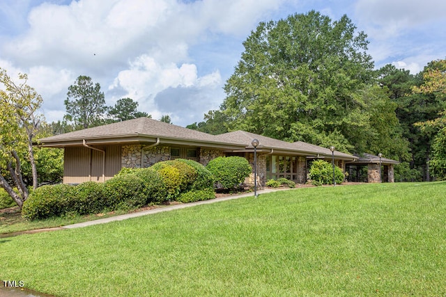 view of front of house featuring a front yard and stone siding