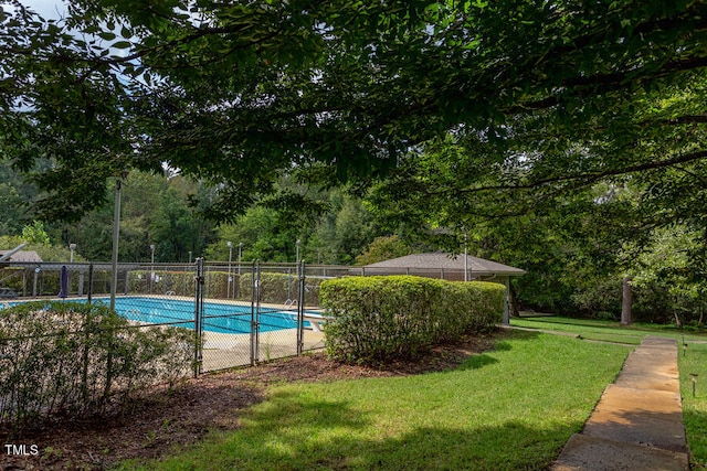 pool featuring a lawn and fence