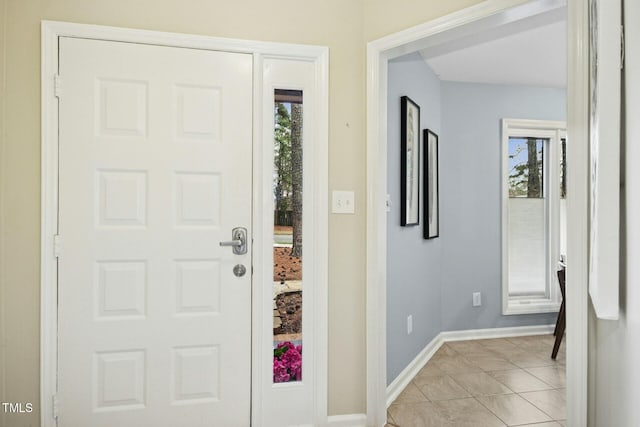 entryway featuring light tile patterned floors and baseboards