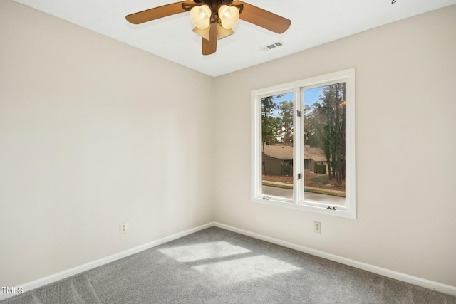 carpeted empty room featuring visible vents, baseboards, and a ceiling fan