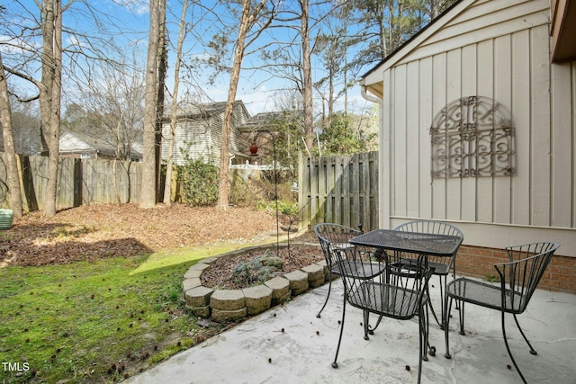 view of patio featuring outdoor dining area and fence