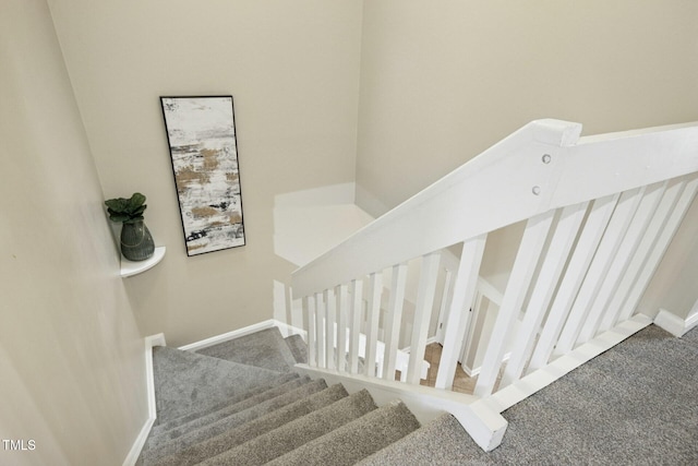 stairs with baseboards and carpet floors