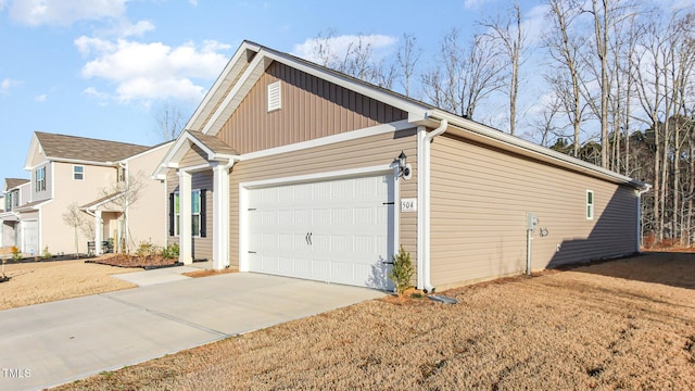 view of home's exterior featuring a lawn, an attached garage, and concrete driveway