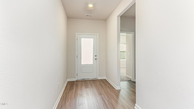 entryway featuring visible vents, baseboards, and light wood-style floors