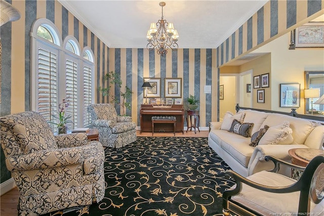 living room with baseboards, a notable chandelier, ornamental molding, and wallpapered walls