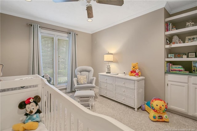 bedroom featuring carpet flooring, a ceiling fan, crown molding, and a nursery area