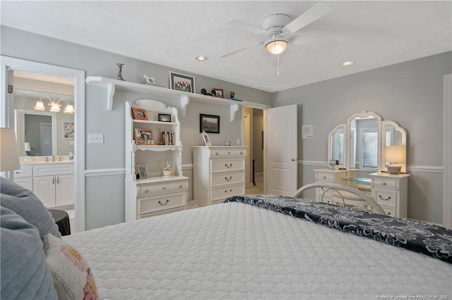 bedroom with recessed lighting, ensuite bathroom, and ceiling fan with notable chandelier