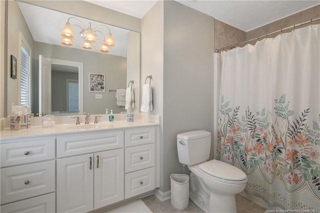 full bathroom featuring curtained shower, toilet, a chandelier, and vanity