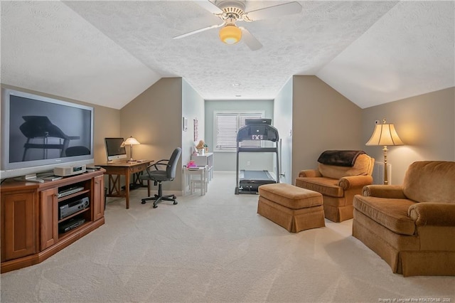 home office featuring a textured ceiling, a ceiling fan, baseboards, vaulted ceiling, and light carpet