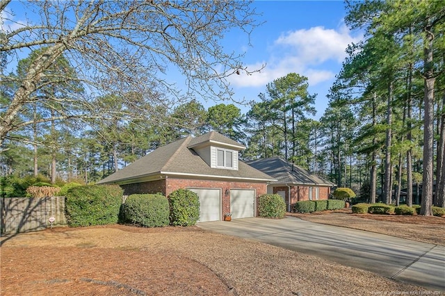 view of home's exterior with brick siding, driveway, and a garage