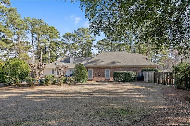 ranch-style house with fence and brick siding