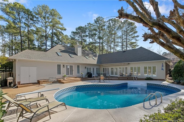 outdoor pool featuring french doors, a patio, grilling area, and entry steps