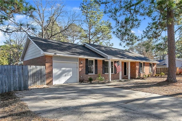 single story home featuring brick siding, driveway, a garage, and fence