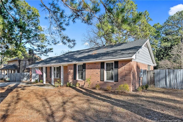 ranch-style home with brick siding and fence