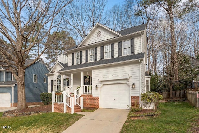 view of front of home with a front yard, an attached garage, fence, and concrete driveway