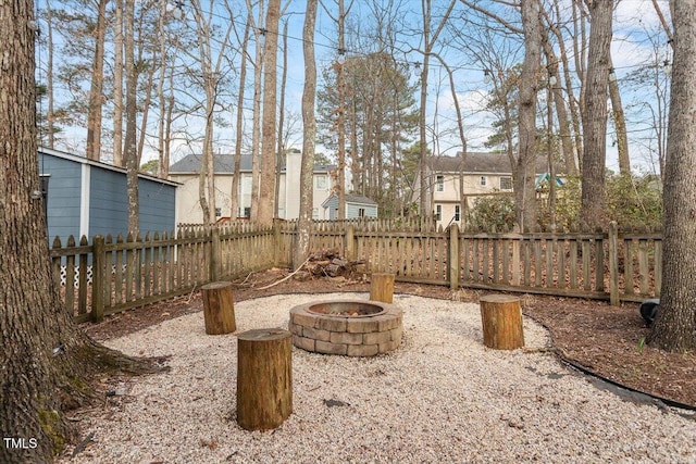 view of yard with fence, a residential view, and a fire pit