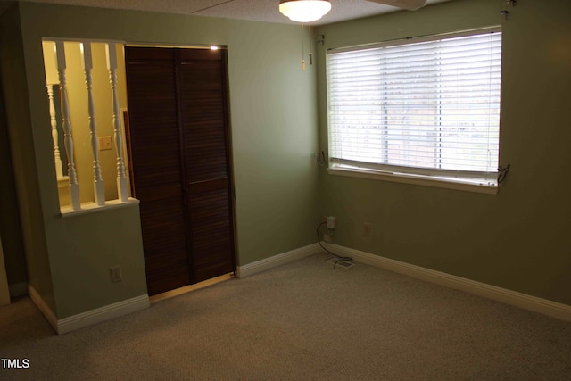 unfurnished bedroom featuring a closet, ceiling fan, baseboards, and carpet floors