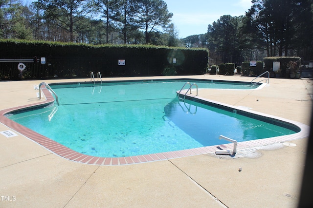 pool featuring a patio and fence