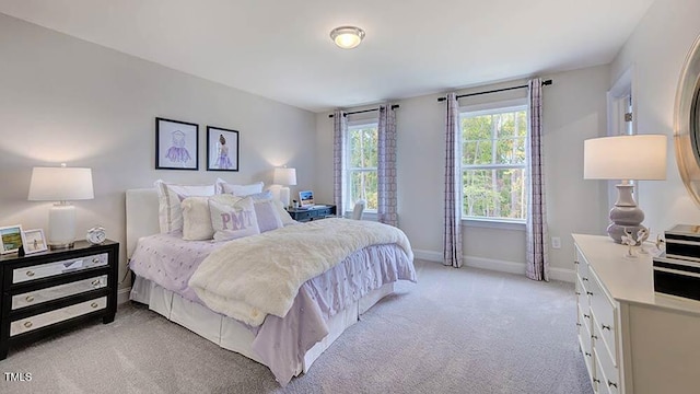 bedroom featuring baseboards and light colored carpet