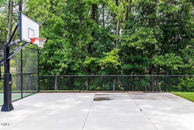 view of basketball court with community basketball court and fence