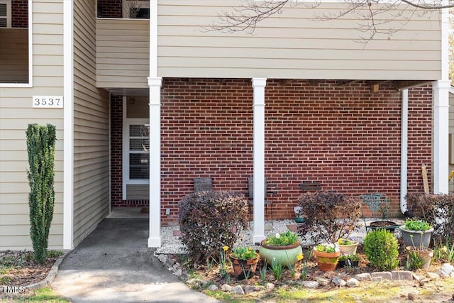 view of exterior entry with brick siding