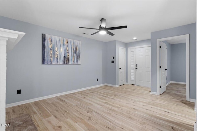 interior space featuring visible vents, baseboards, and light wood finished floors