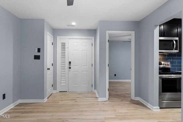 entryway with visible vents, baseboards, and light wood-style flooring