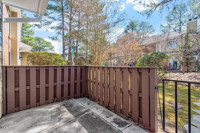 view of patio featuring fence