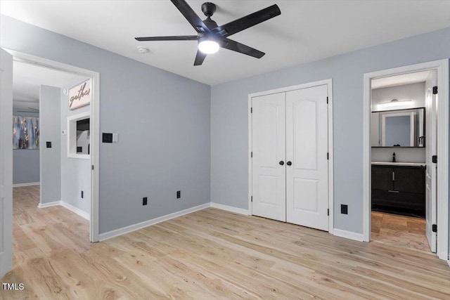 unfurnished bedroom featuring a closet, baseboards, and light wood-style floors