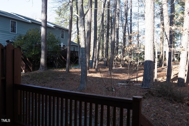 view of yard featuring stairs and fence