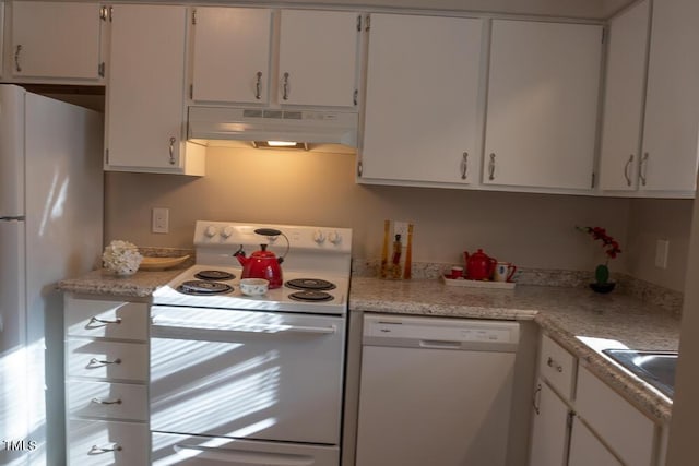 kitchen with under cabinet range hood, white appliances, white cabinets, and light countertops