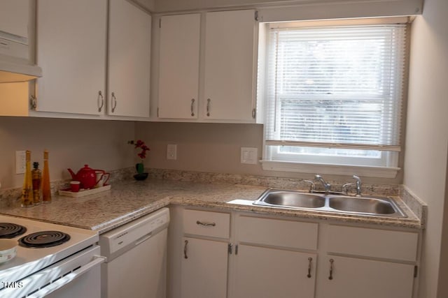 kitchen featuring white appliances, white cabinetry, light countertops, and a sink