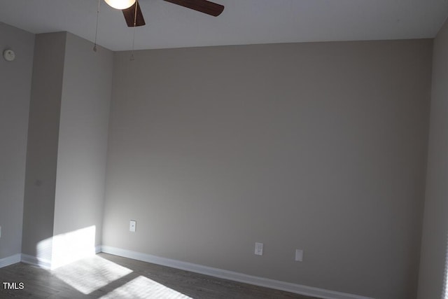 unfurnished room featuring a ceiling fan and baseboards