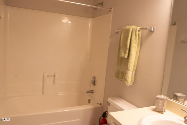 bathroom with toilet, vanity, and shower / tub combination