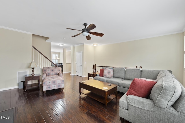 living room featuring crown molding, a ceiling fan, visible vents, and wood-type flooring