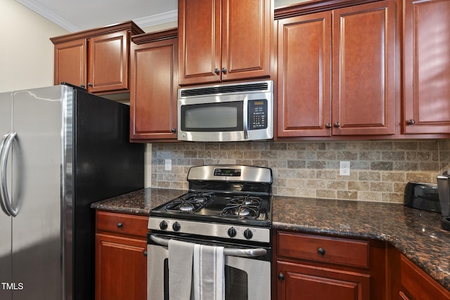 kitchen featuring dark stone counters, backsplash, appliances with stainless steel finishes, and ornamental molding