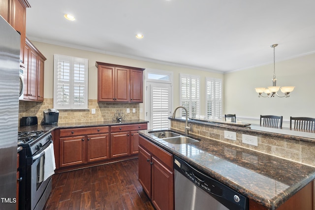 kitchen with dark wood-type flooring, ornamental molding, decorative backsplash, stainless steel appliances, and a sink